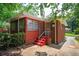Exterior view of the brick house with a cozy sunroom, red painted stairs, and white railings leading to the entrance at 2581 N Clark Dr, Atlanta, GA 30344