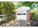 Detached garage with white door and brick accents, surrounded by greenery at 2581 N Clark Dr, Atlanta, GA 30344