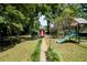 Large backyard with a playset, a red storage shed, trampoline and a green lawn, great for recreation at 4138 Hickory Dr, Powder Springs, GA 30127