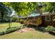 Beautiful backyard with a wooden deck, lush lawn, trees, and a swing set, perfect for outdoor enjoyment at 4138 Hickory Dr, Powder Springs, GA 30127