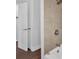 Bathroom with a white tile shower, bathtub, and modern fixtures at 4138 Hickory Dr, Powder Springs, GA 30127