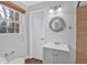 Cozy bathroom with neutral paint, updated vanity, and a window for natural light at 4138 Hickory Dr, Powder Springs, GA 30127