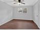 This bedroom features wood-look flooring, a ceiling fan, neutral paint, and a window for natural light at 4138 Hickory Dr, Powder Springs, GA 30127