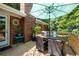 Inviting outdoor deck with a dining table, chairs, and an umbrella, ideal for entertaining at 4138 Hickory Dr, Powder Springs, GA 30127