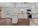 Modern kitchen featuring white cabinets, stainless steel appliances, and beautiful stone countertops with a breakfast bar at 4138 Hickory Dr, Powder Springs, GA 30127