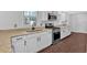 Bright kitchen with granite countertops, stainless steel appliances and white cabinets at 4138 Hickory Dr, Powder Springs, GA 30127