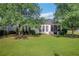 Spacious backyard with lush green lawn and screened-in porch, perfect for entertaining at 4140 Prince Charles Dr, Duluth, GA 30097