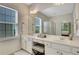Elegant bathroom with double sinks, granite countertops, and a walk-in shower with ample natural light at 4140 Prince Charles Dr, Duluth, GA 30097