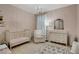 This lovely Bedroom has a crib, comfortable chair, and elegant chandelier at 4140 Prince Charles Dr, Duluth, GA 30097