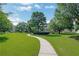 A beautiful community green space featuring walking paths and lush landscaping at 4140 Prince Charles Dr, Duluth, GA 30097