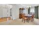 Formal dining room adjacent to foyer featuring hardwood floors, a cabinet, and seating for six at 4140 Prince Charles Dr, Duluth, GA 30097