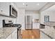Modern kitchen with stainless steel appliances, granite countertops, and ample cabinet space at 4140 Prince Charles Dr, Duluth, GA 30097