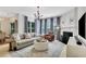 Comfortable living room with fireplace, couch, ottoman, and large window for natural light at 4140 Prince Charles Dr, Duluth, GA 30097