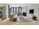 Cozy living room with fireplace, plush sofa, neutral tones, and large window for natural light at 4140 Prince Charles Dr, Duluth, GA 30097