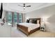 Serene primary bedroom with tray ceilings, large windows, and comfortable furnishings, creating a relaxing retreat at 4140 Prince Charles Dr, Duluth, GA 30097