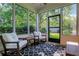 Relaxing screened porch with rocking chairs, perfect for enjoying the outdoors at 4140 Prince Charles Dr, Duluth, GA 30097