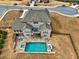 Stunning aerial view of a home with a private pool, spa, and patio at 5540 Wood Falls Dr, Buford, GA 30518