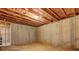 Unfinished basement with concrete walls and exposed ceiling insulation at 5540 Wood Falls Dr, Buford, GA 30518