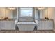 Bright bathroom featuring a soaking tub, double vanities, granite countertops, and tiled floors at 5540 Wood Falls Dr, Buford, GA 30518