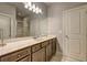 Neutral bathroom with modern vanity, large mirror, shower, and tile flooring at 5540 Wood Falls Dr, Buford, GA 30518