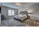 Spacious bedroom with carpet flooring, neutral color palette, and a large bed at 5540 Wood Falls Dr, Buford, GA 30518