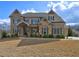 Beautiful two-story brick home featuring stone accents and a well-manicured front lawn at 5540 Wood Falls Dr, Buford, GA 30518