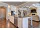 Modern kitchen with island, stainless steel appliances and hardwood floors at 5540 Wood Falls Dr, Buford, GA 30518