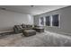 Cozy living room with plush carpet, sectional sofa, and abundant natural light at 5540 Wood Falls Dr, Buford, GA 30518
