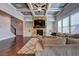 Spacious living room with a stone fireplace, coffered ceiling, and hardwood floors at 5540 Wood Falls Dr, Buford, GA 30518
