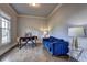 Cozy home office with a modern desk and comfortable blue sofa at 5540 Wood Falls Dr, Buford, GA 30518