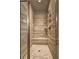 Modern shower stall with a glass door, built-in seat, and tiled surround at 5540 Wood Falls Dr, Buford, GA 30518