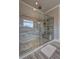 Contemporary shower with a glass enclosure, rainfall shower head, and tiled walls at 5540 Wood Falls Dr, Buford, GA 30518