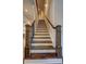 Beautiful staircase with dark wood steps, white risers, and decorative posts at 5540 Wood Falls Dr, Buford, GA 30518