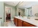 Bathroom with double sinks, granite countertops, walk-in shower, and a view into the closet at , Conyers, GA 30012