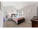 Bright bedroom featuring plush carpet, a comfortable bed, and a view of the neighborhood at , Conyers, GA 30012