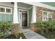 Close up of a front door with stone accents and light green siding at , Conyers, GA 30012