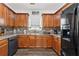 Kitchen featuring dark cabinets, tile backsplash, and dark appliances at , Conyers, GA 30012