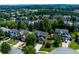 Aerial view of a neighborhood with mature trees and well-maintained homes at 213 Roseman Way, Woodstock, GA 30188