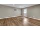 Large basement room with vinyl floors and a white door with windows at 213 Roseman Way, Woodstock, GA 30188