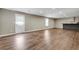 Open basement area featuring vinyl floors, a door to the backyard, and a counter with a sink at 213 Roseman Way, Woodstock, GA 30188