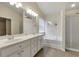 Bright bathroom boasts double vanity, large mirror, soaking tub, and glass shower enclosure at 213 Roseman Way, Woodstock, GA 30188