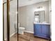 Bathroom featuring a modern vanity, mirror, toilet and glass-enclosed shower at 213 Roseman Way, Woodstock, GA 30188