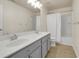 Bathroom features a double sink vanity, large mirror, and shower-tub combination at 213 Roseman Way, Woodstock, GA 30188