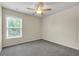Bedroom featuring a ceiling fan, window and neutral carpet at 213 Roseman Way, Woodstock, GA 30188