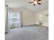 Well-lit bedroom with vaulted ceiling, fan, plush carpet, and access to ensuite bathroom at 213 Roseman Way, Woodstock, GA 30188
