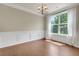 Dining room has hardwood floors, large windows, and decorative wainscoting at 213 Roseman Way, Woodstock, GA 30188