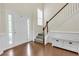 Inviting foyer with hardwood floors, a staircase with white railings, and wainscoting at 213 Roseman Way, Woodstock, GA 30188