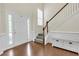 Inviting foyer featuring hardwood floors, staircase, and a large front door with sidelights at 213 Roseman Way, Woodstock, GA 30188
