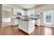 Bright, modern kitchen with white cabinets, stainless steel appliances, and a center island at 213 Roseman Way, Woodstock, GA 30188