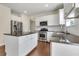 Modern kitchen with stainless steel appliances, white cabinets, and granite countertops at 213 Roseman Way, Woodstock, GA 30188